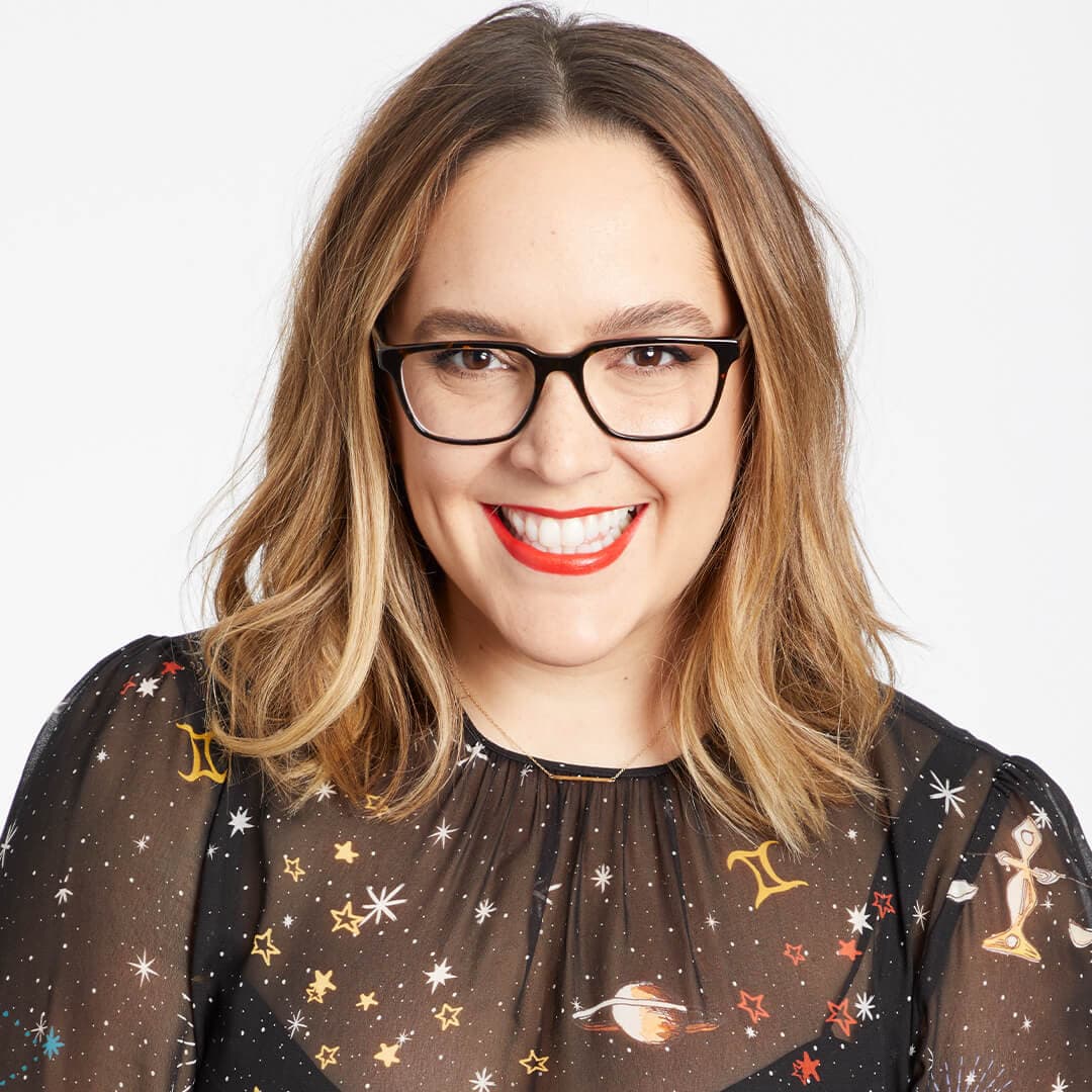 Close-up image of Marta Topran smiling big against a white background