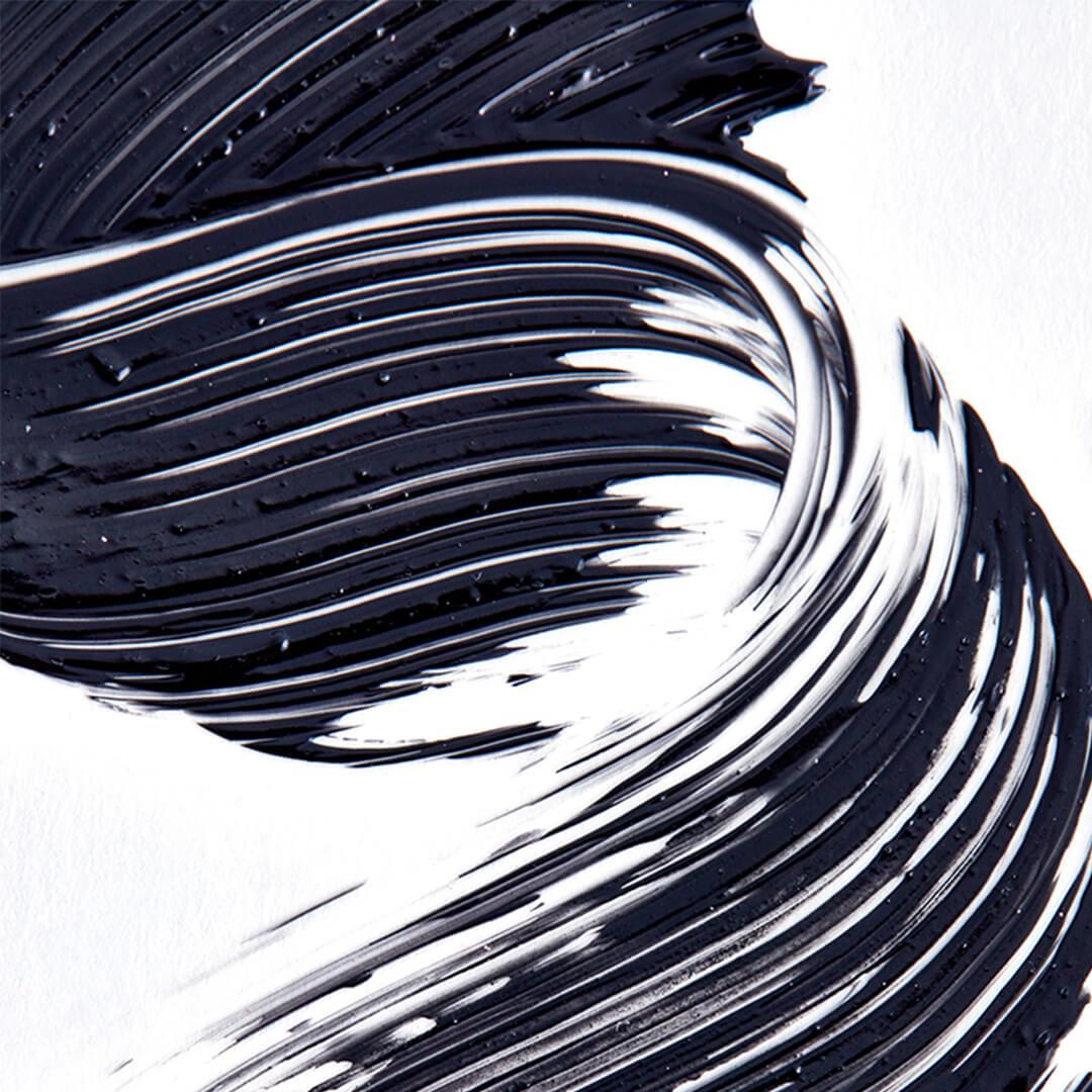 A closeup photo of strokes of mascara on a white background