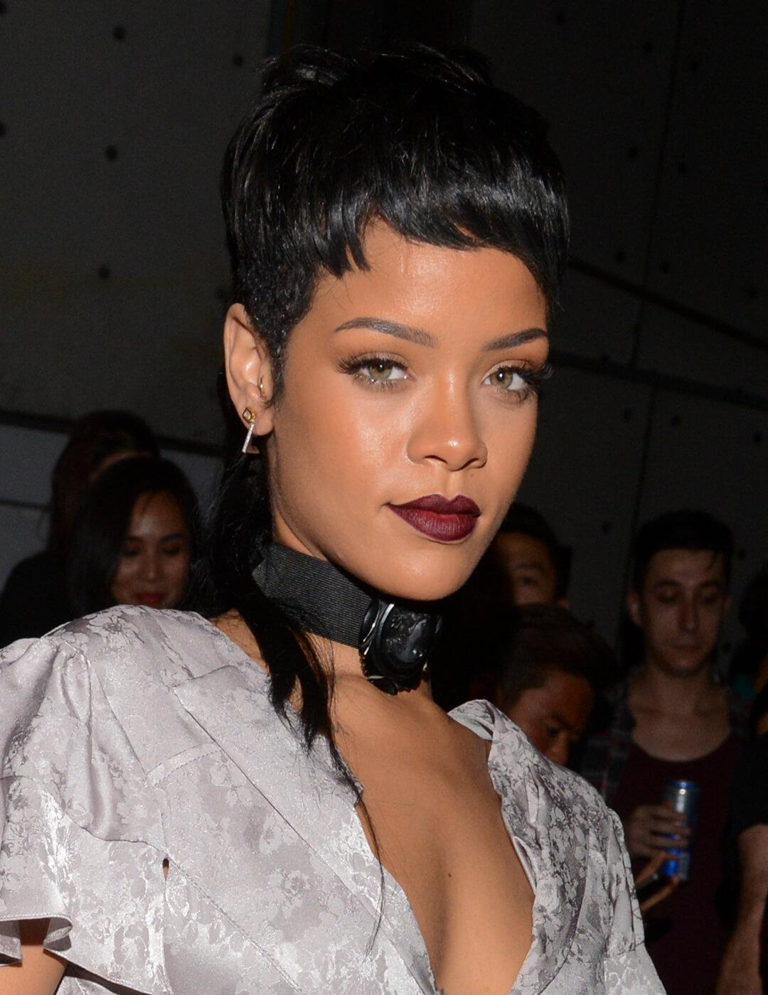 A photo of Rihanna wearing a silver minidress and a black choker rocking her pixie undercut hip-punk mullet style