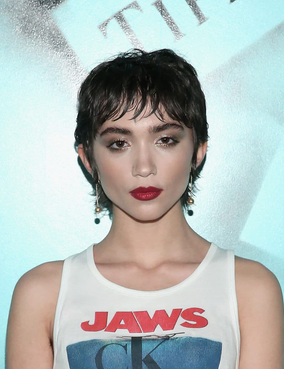 A photo of Rowan Blanchard wearing a Jaws printed crop top in her black short mullet 