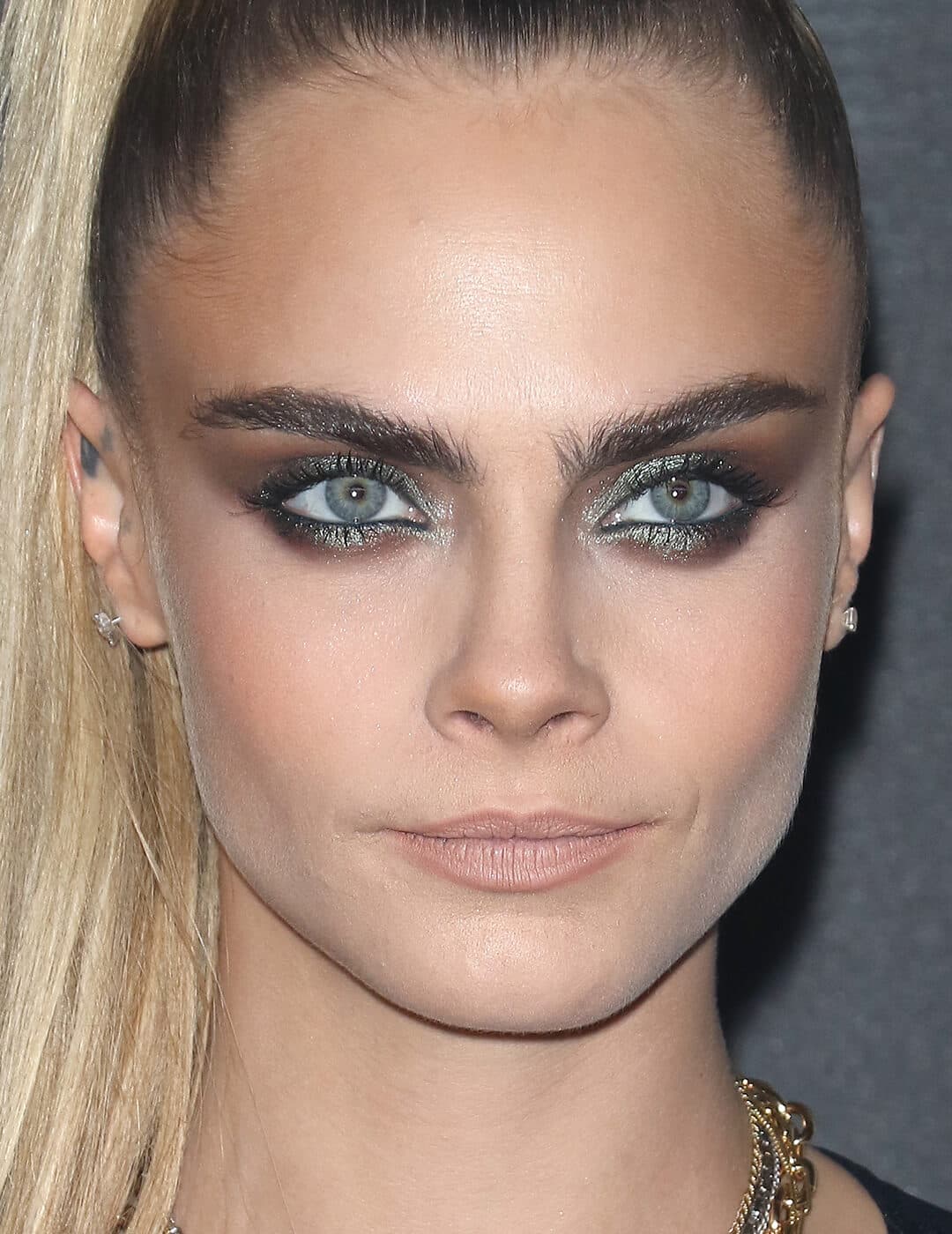 Cara Delevingne rocking a bold smoky eyeshadow makeup look paired with nude lips