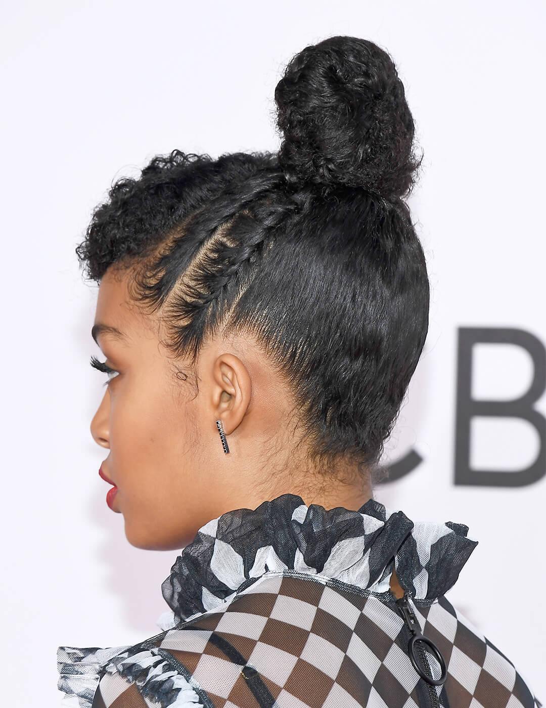 Yara Shahidi in a checkered black and white dress showing the back of her top knot and cornrows hairstyle