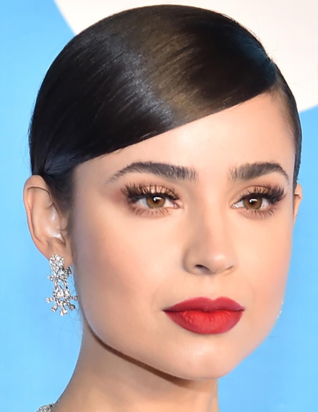 A photo of Sofia Carson with nude eyeshadow and red lips 