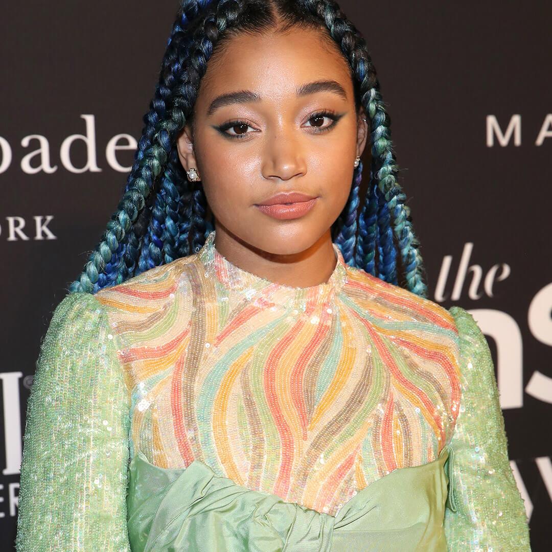 A photo of Amandla Stenberg with blue and teal braids