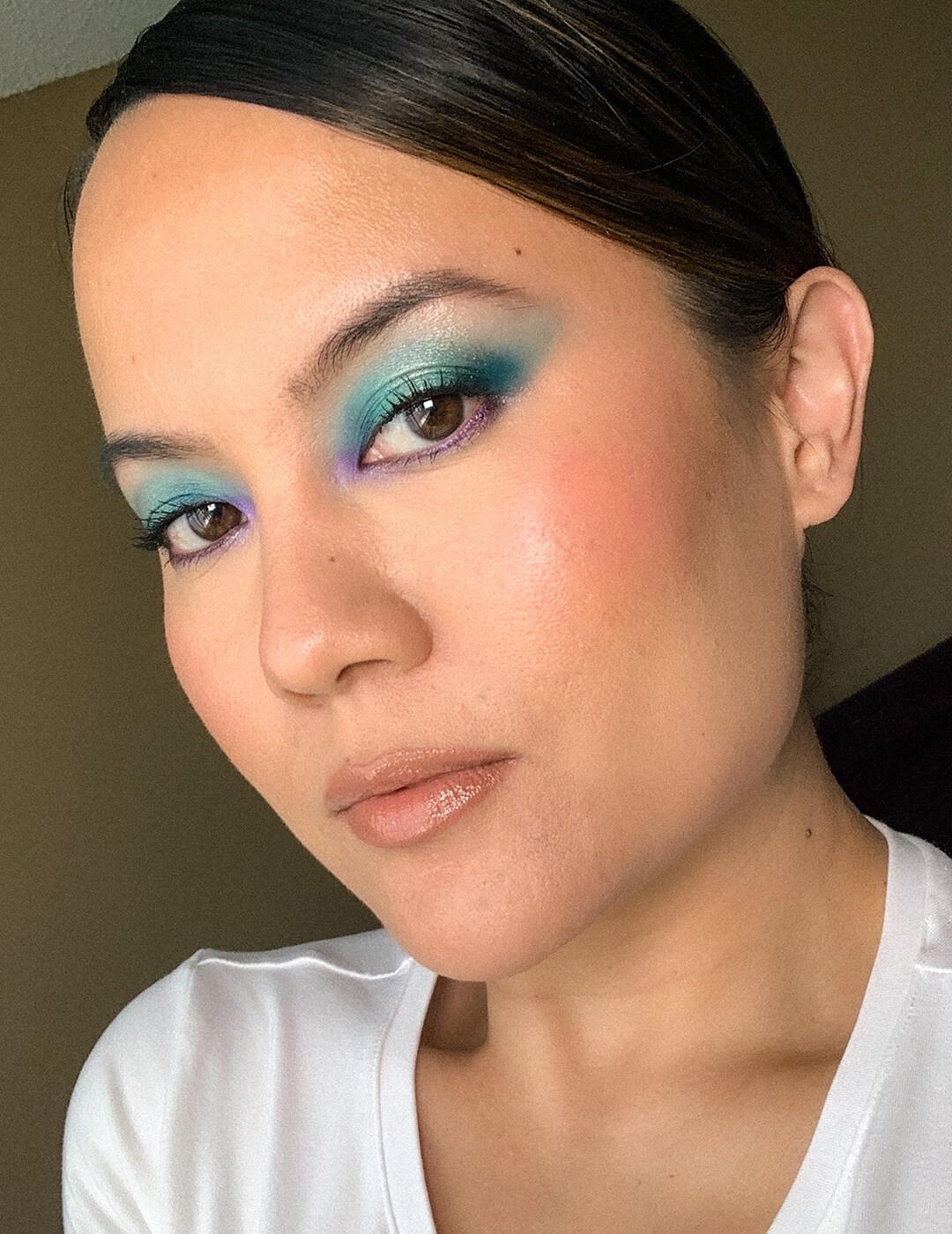 Close-up of Joy rocking a shimmery teal and lavender eyeshadow look