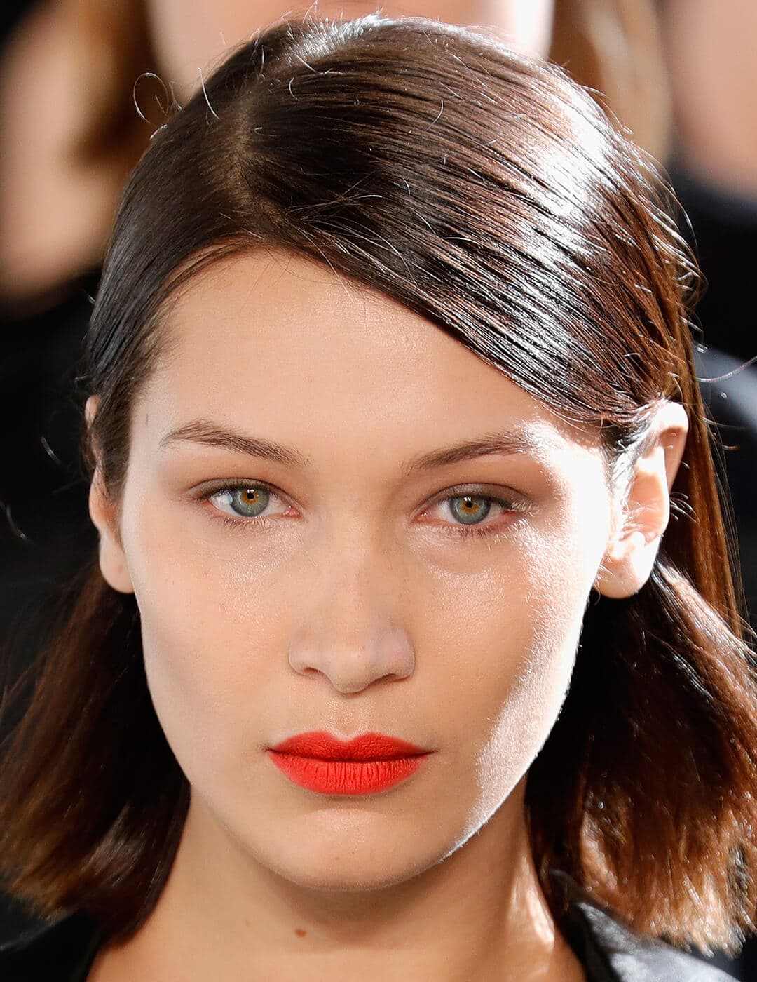 Bella Hadid rocking a clean makeup look paired with bold red lips