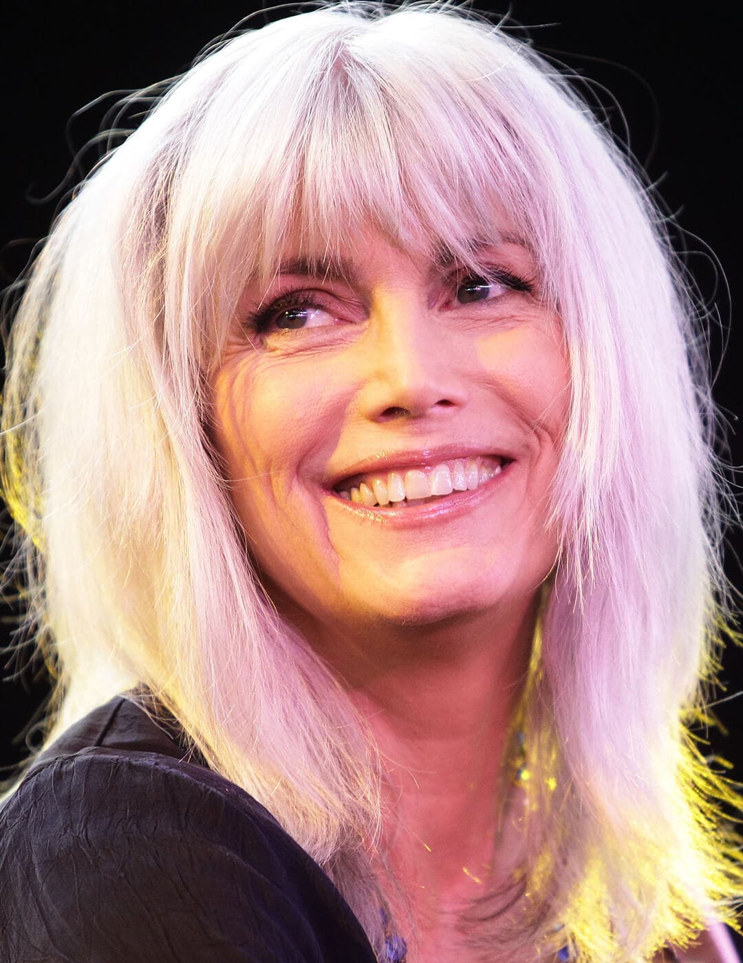 A photo of Emmylou Harris with a soft silvery white hairstyle
