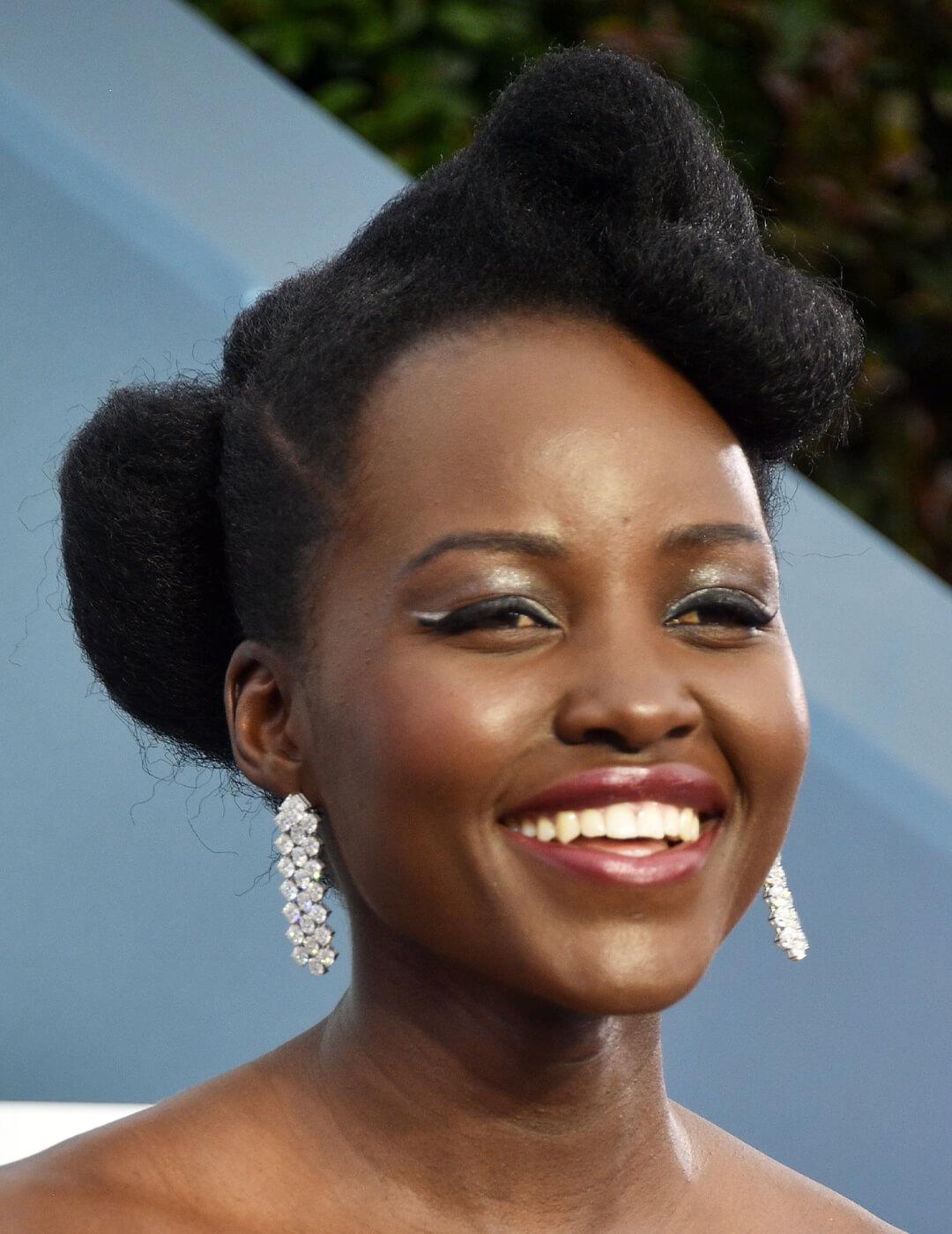 Lupita Nyong'o rocking a glamorous look paired with an updo hairstyle