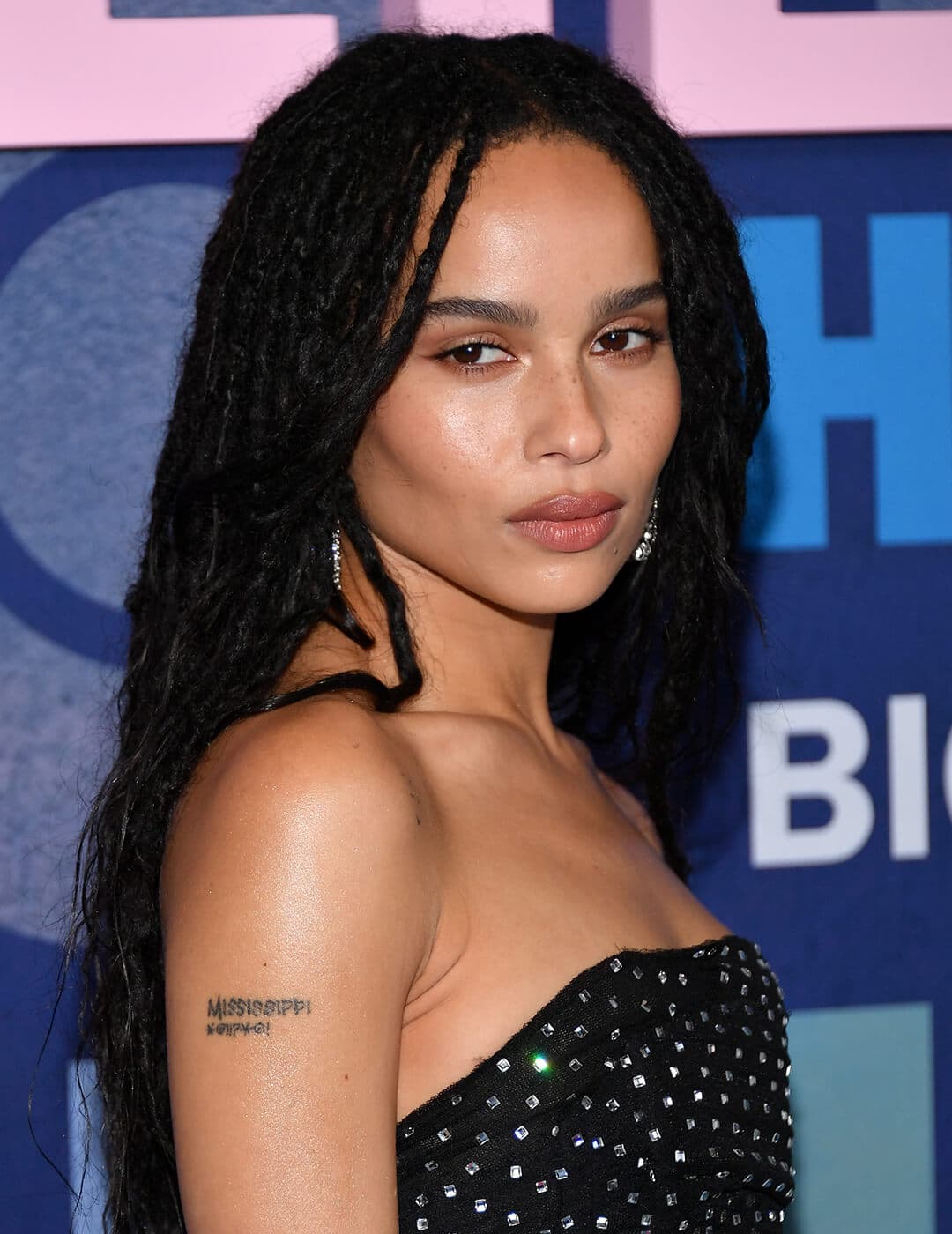 Zoë Kravitz rocking a loose braided hairstyle and black sequined dress on the red carpet