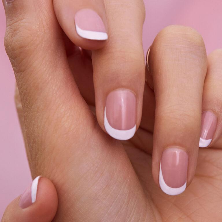 A closeup image of a French tip mani