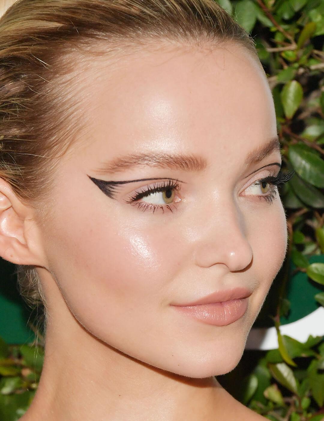 Close-up of Dove Cameron rocking a graphic winged eyeliner look
