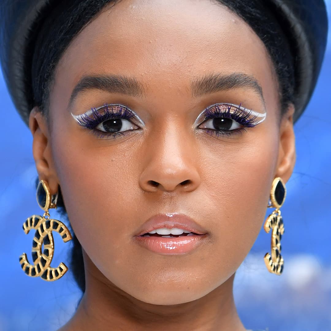 a photo of Janelle Monae with white eyeliner outline, shimmery eyeshadow and purple mascara