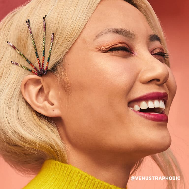 Catherine Pham wearing hair pins with colorful rhinestones smiles