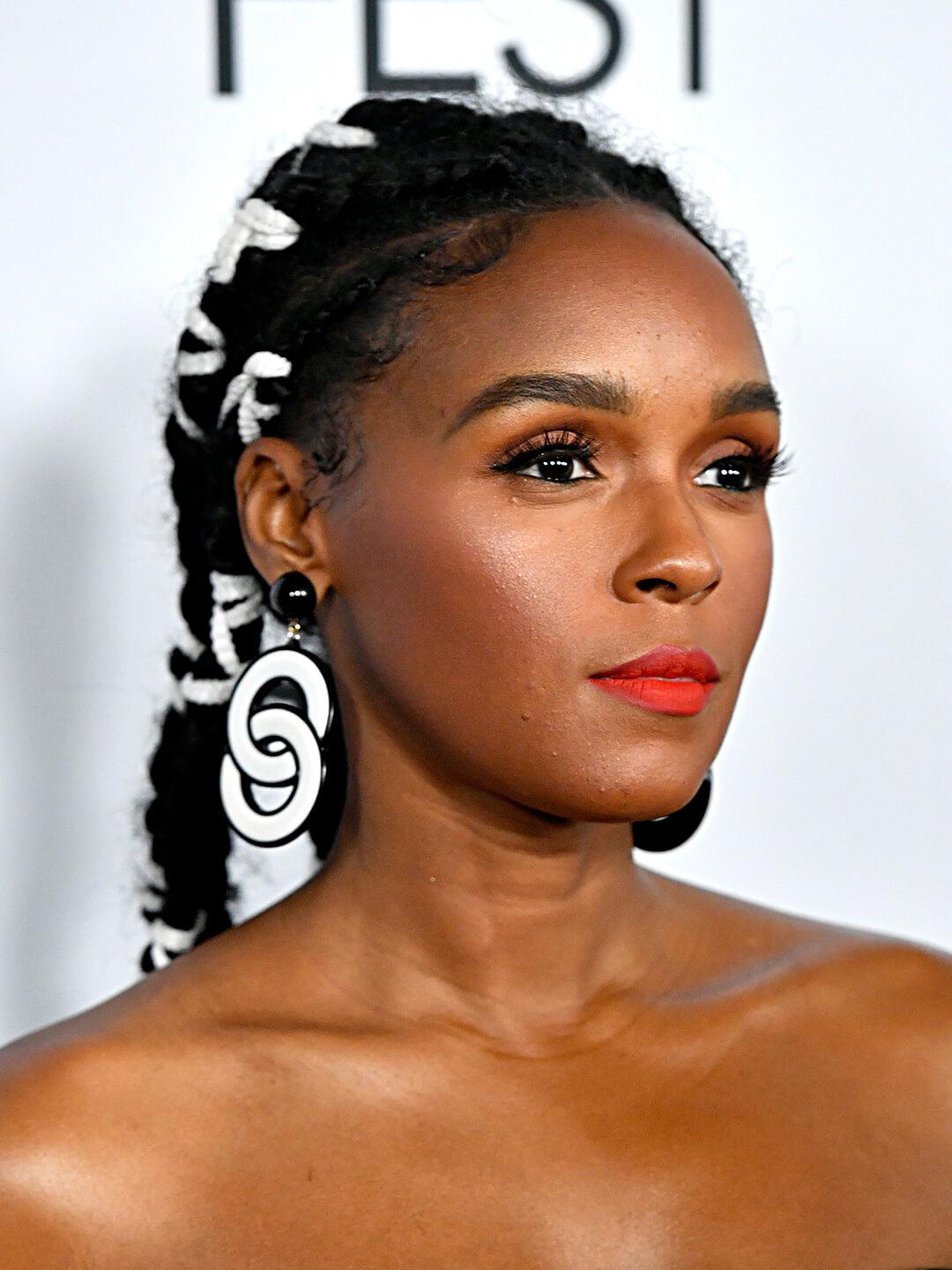 Janelle Monae rocking a threaded braids hairstyle and bold black and white circle earrings