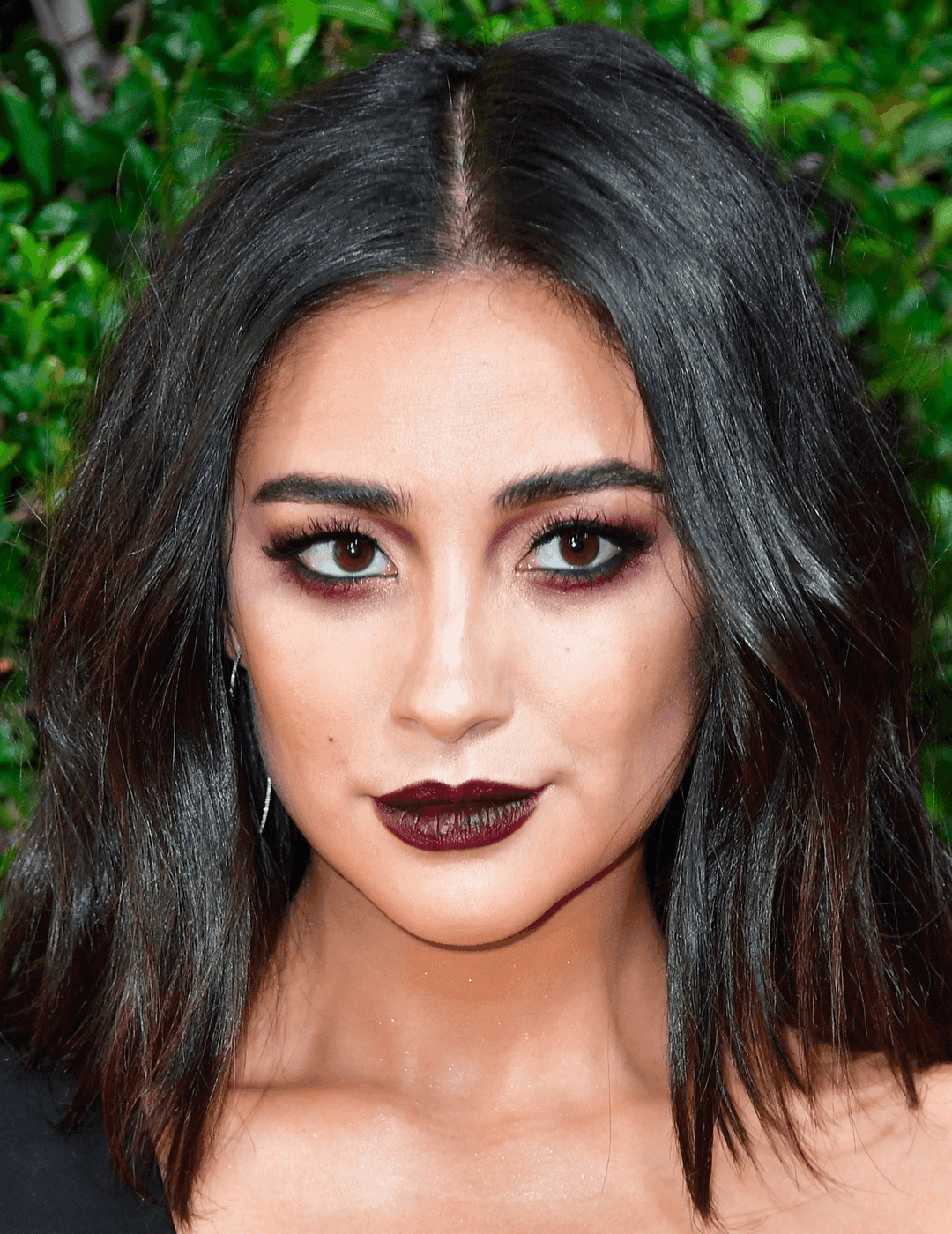 Close-up of Shay Mitchell rocking a deep berry eyeshadow look and deep burgundy lipstick
