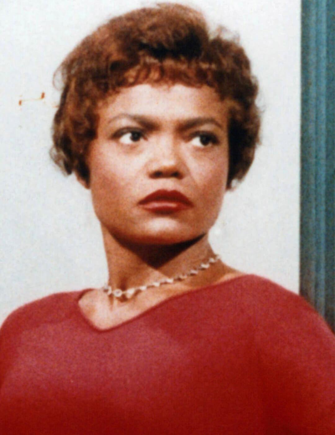 Old portrait of Eartha Kitt in a red dress and gold neclace