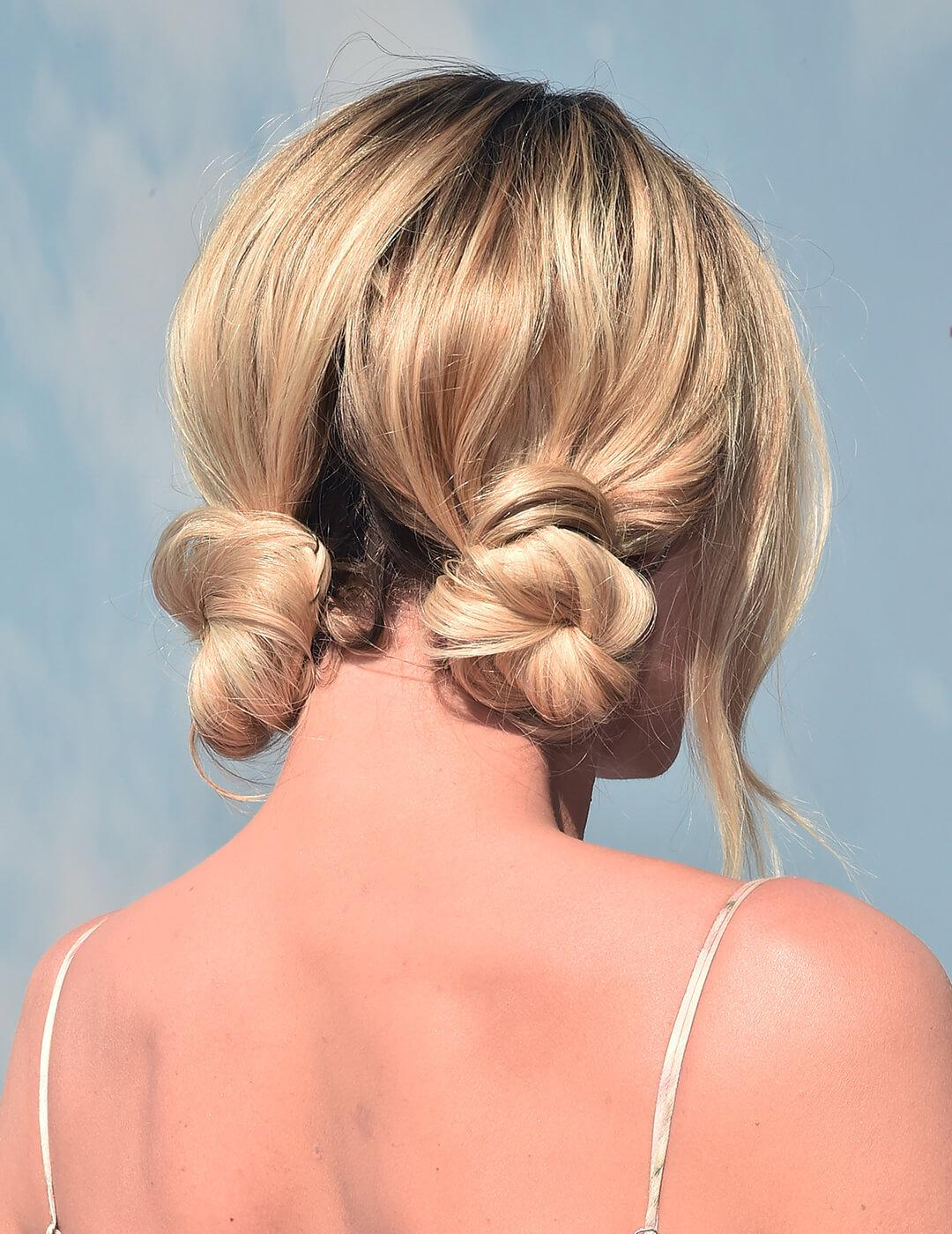Margot Robbie facing back showing off her double knots hairstyle