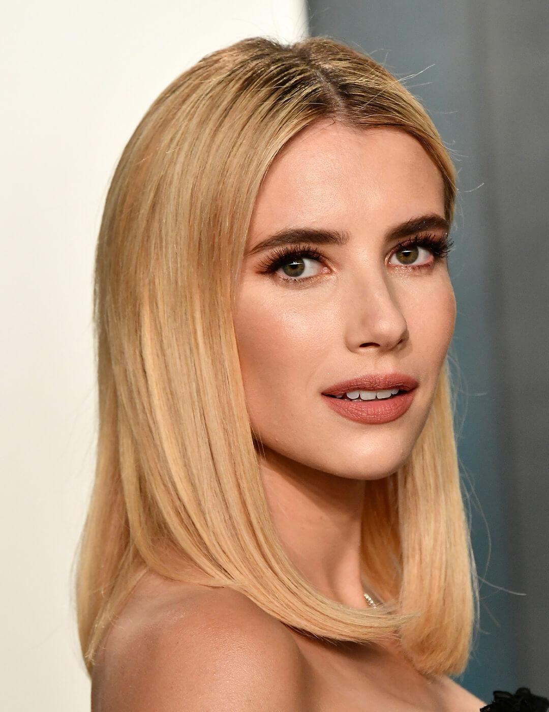 A photo of Emma Roberts with a captivating buttercream blonde hair