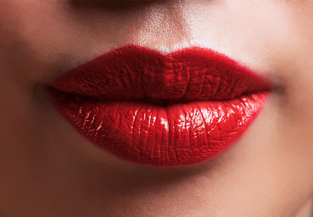 Close-up of a woman's lips with bold red lipstick