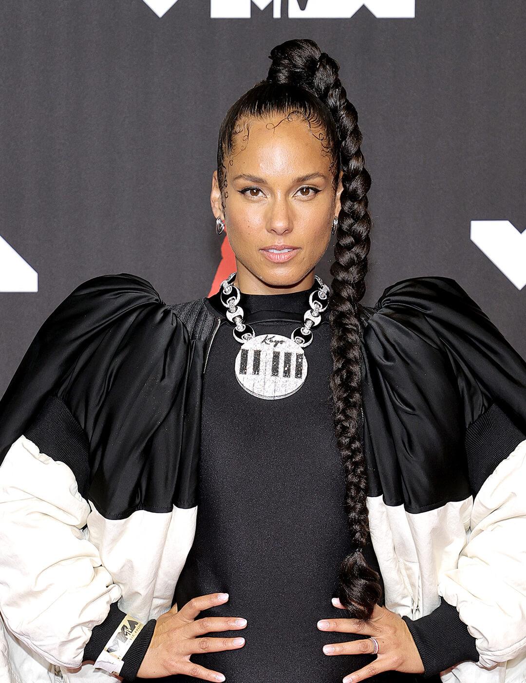 Alicia Keys rocking a braided high ponytail hairstyle and black and white dress on the red carpet