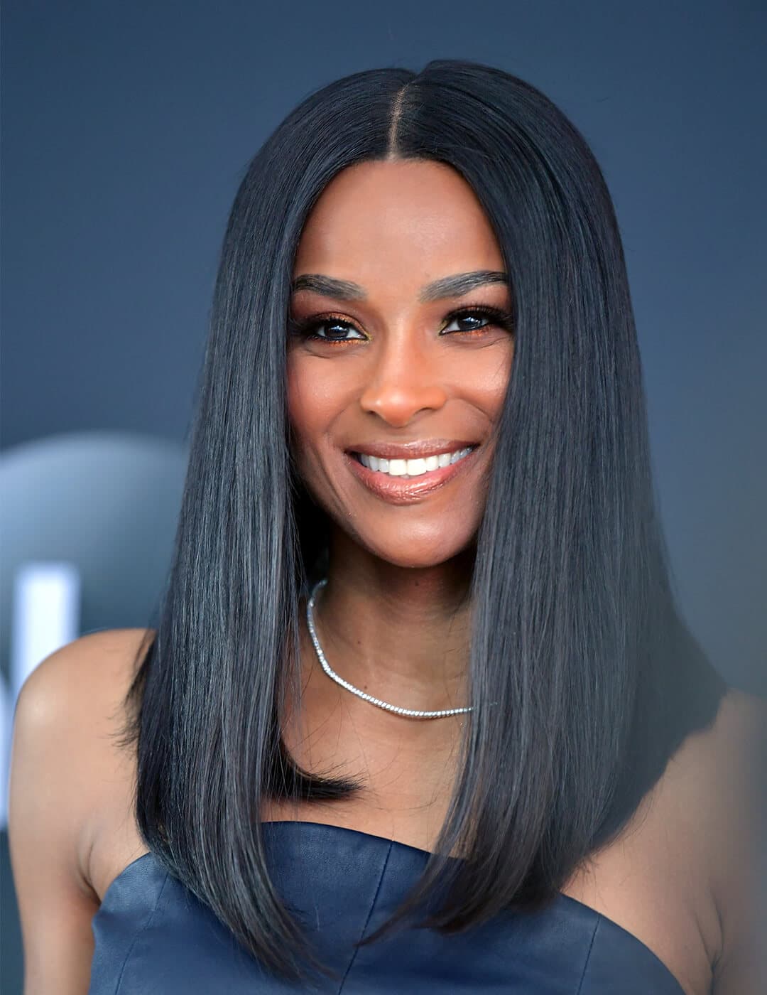 A photo of Ciara with a super long lob hairstyle wearing a white necklace