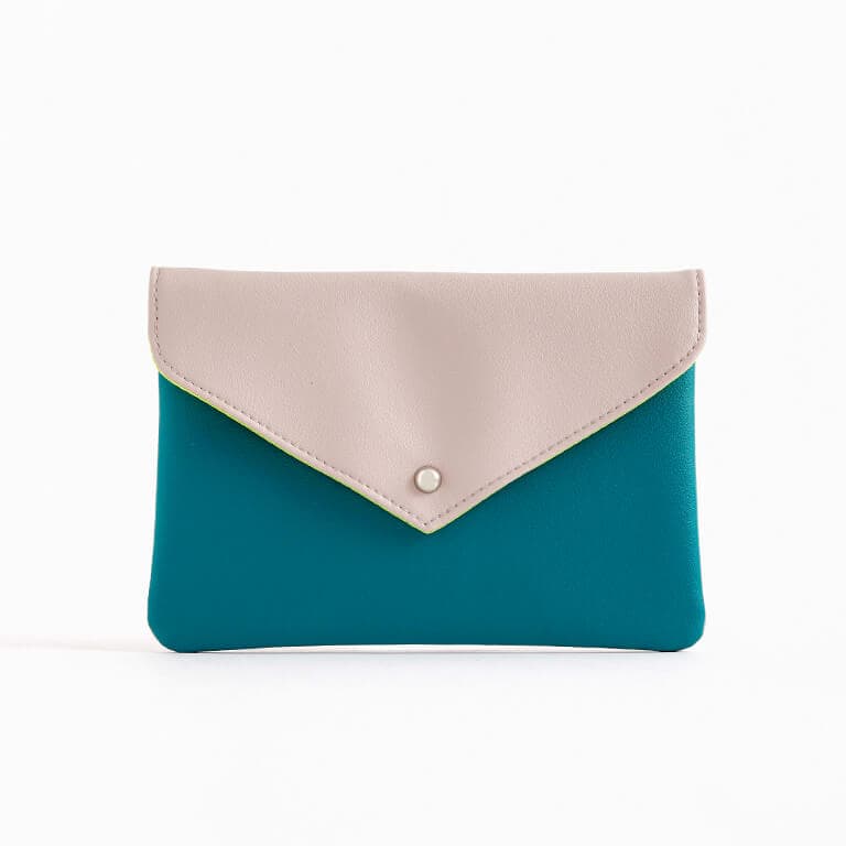 The March 2020 Glam Bag Plus bag is blue-green with a nude pink flap