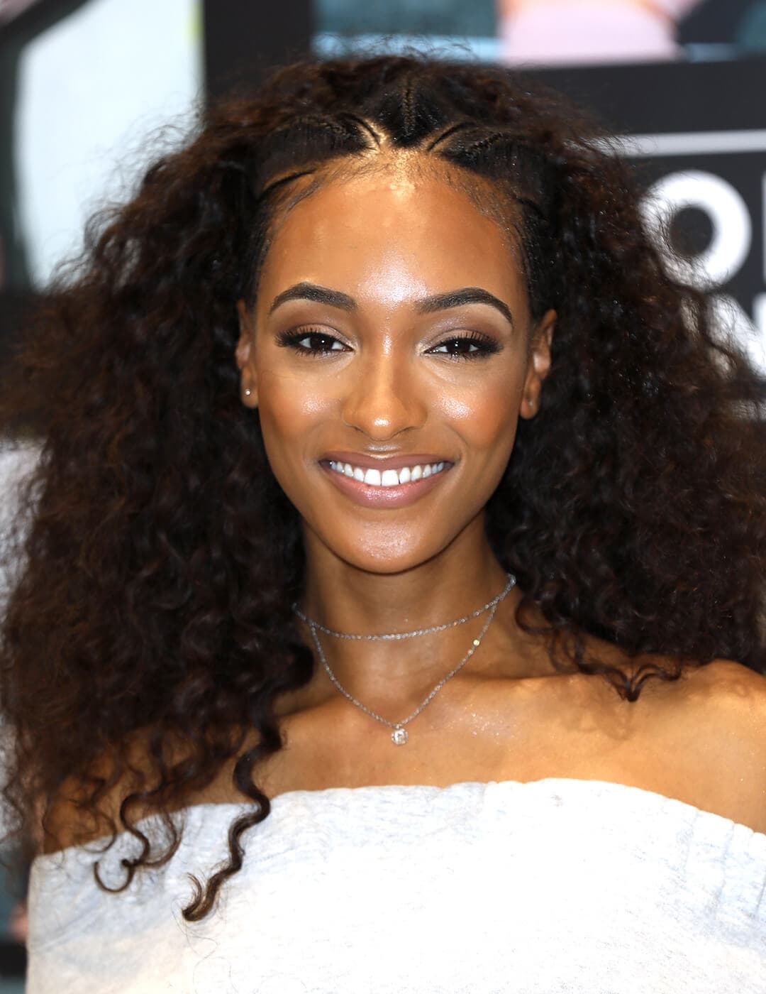Jourdan Dunn looking chic in a white dress and Albasso Braids hairstyle