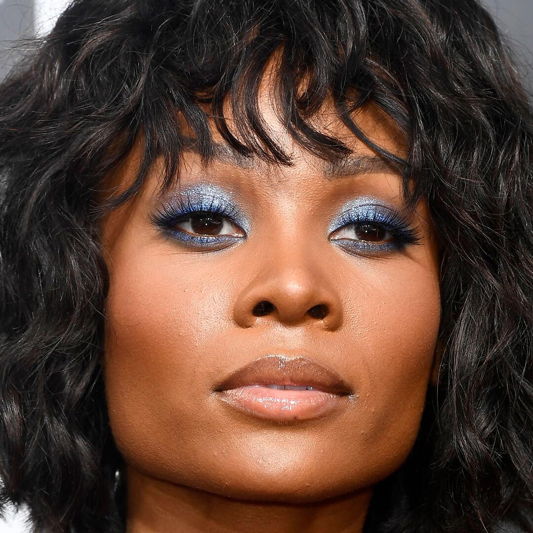 Close-up image of Zuri Hall with shimmery pale blue eyeshadow look paired with nude lips