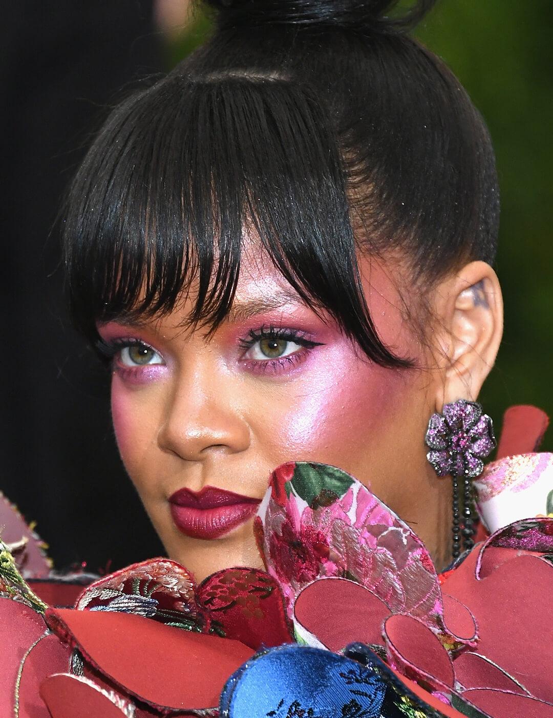 Rihanna rocking an allover blush makeup look and floral and butterfly dress