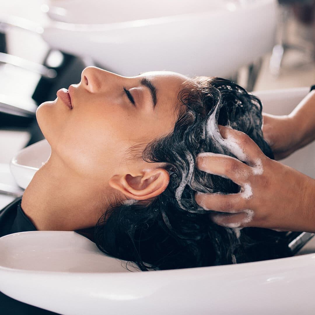 A photo of a model washing her hair at the salon