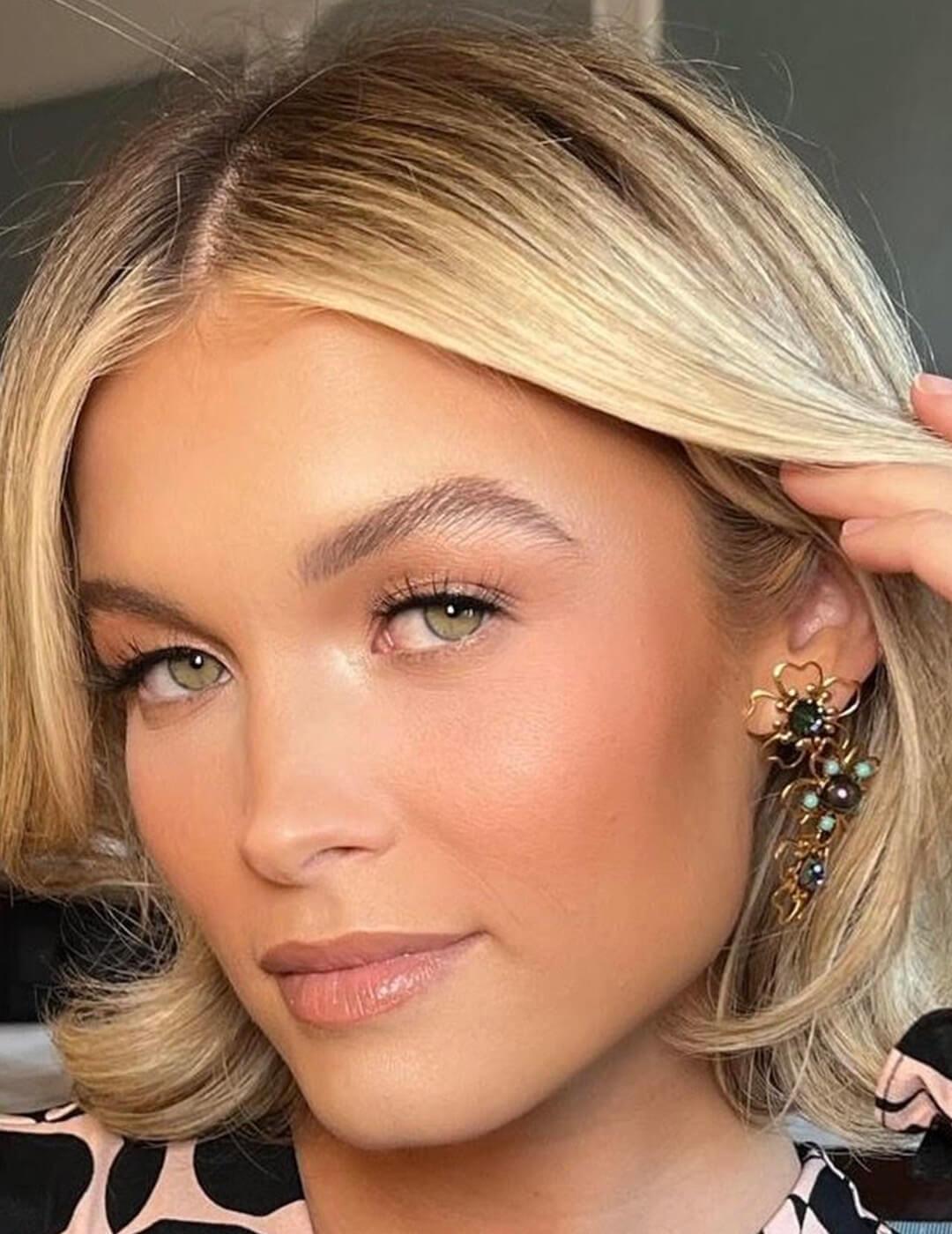 A photo of a model with a dewy bronze makeup look