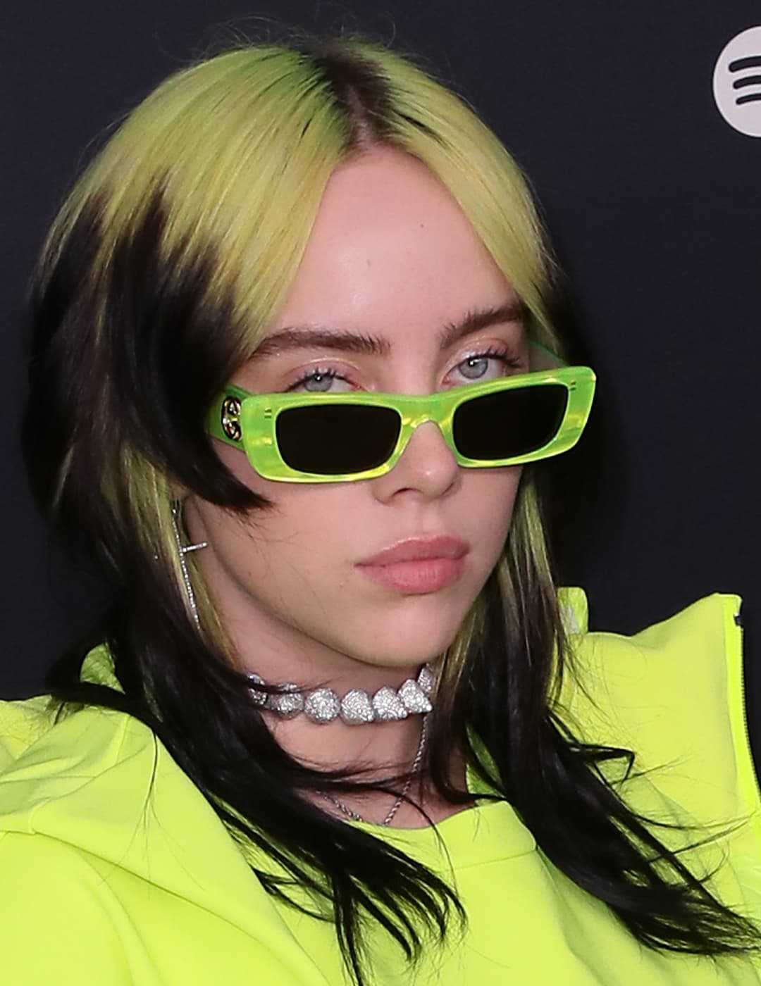 A photo of Billie Eillish with her iconic neon green look