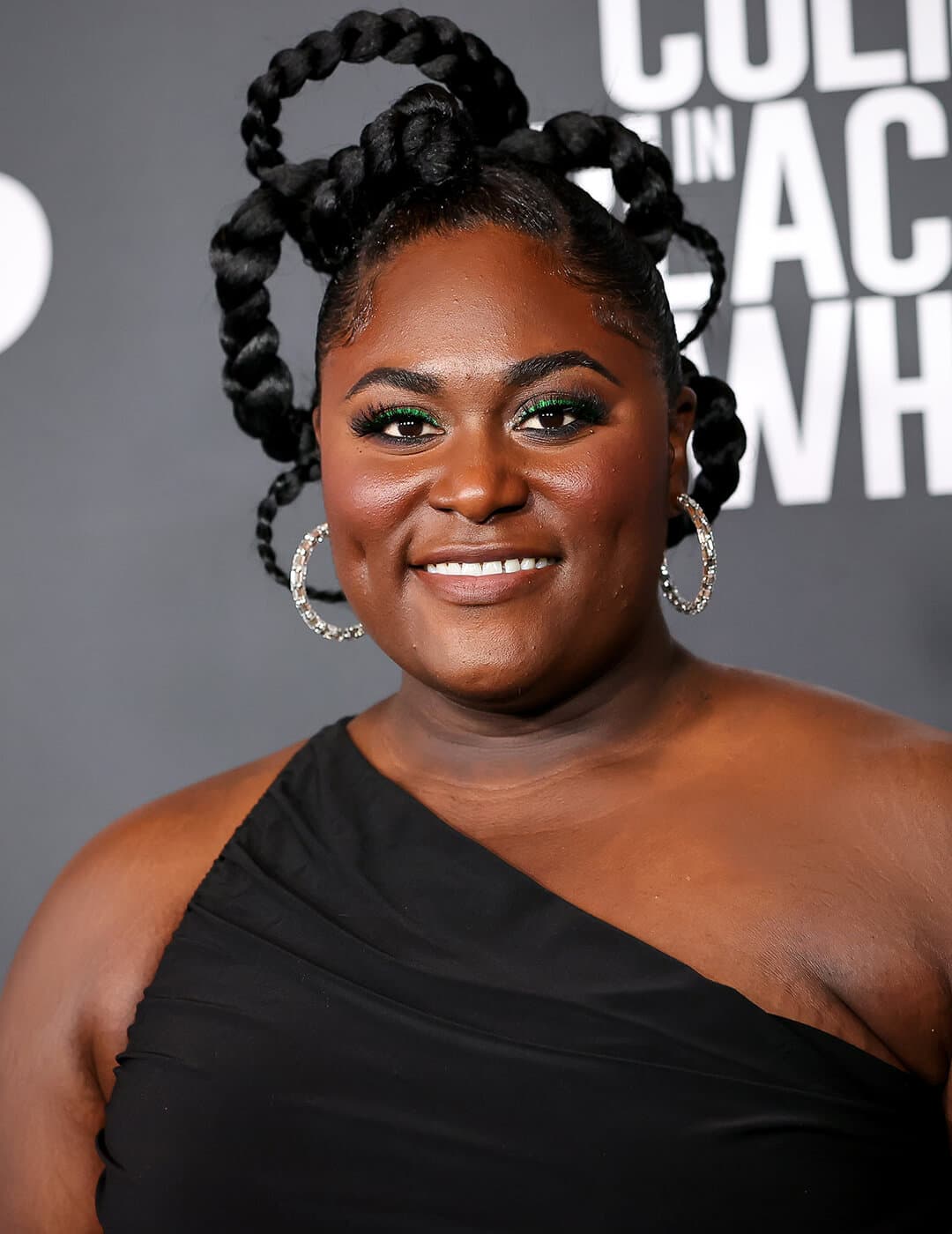 Danielle Brooks rocking a braided loops hairstyle and black dress on the red carpet
