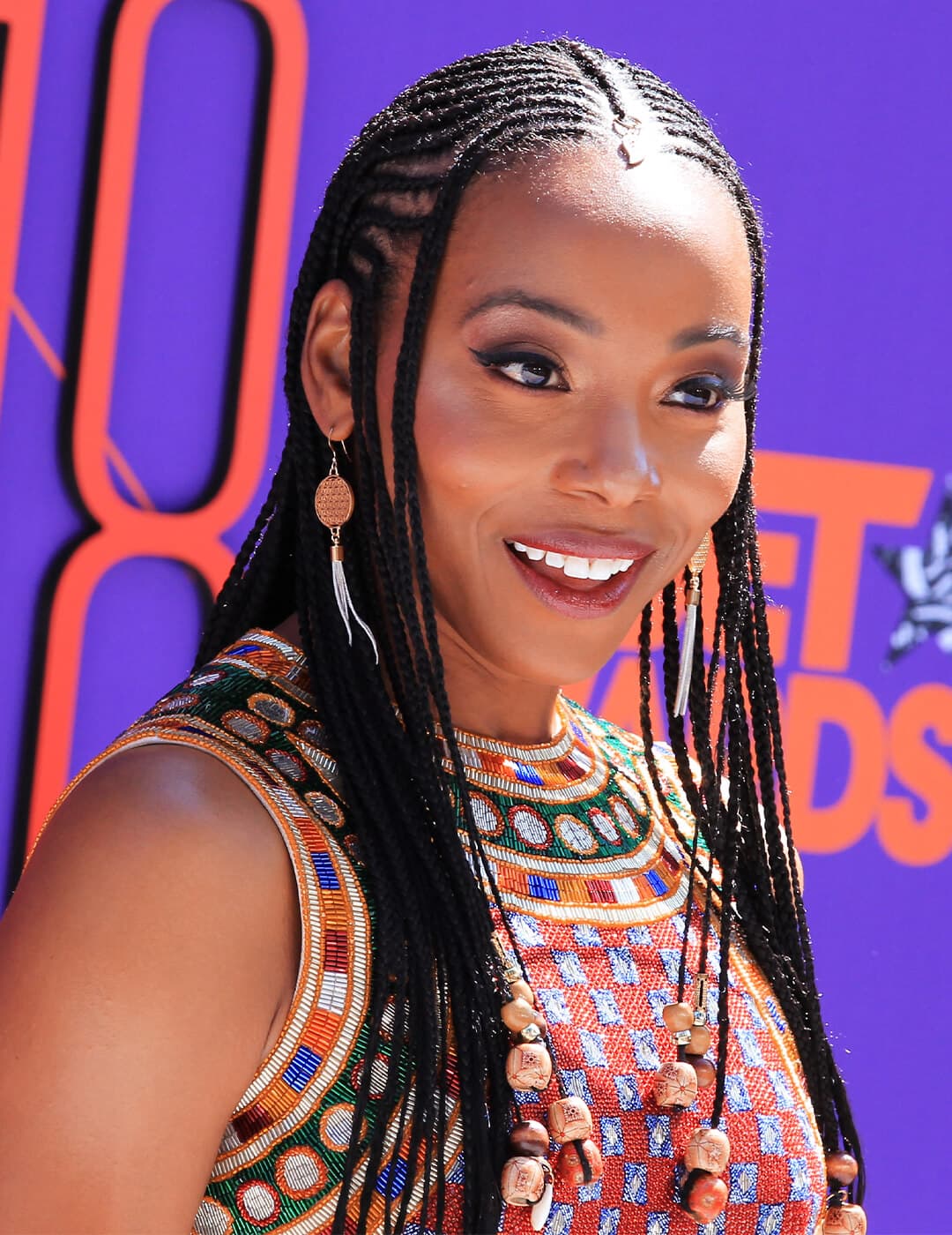 Erica Ash in a tribal patterned outfit rocking her braided hairstyle
