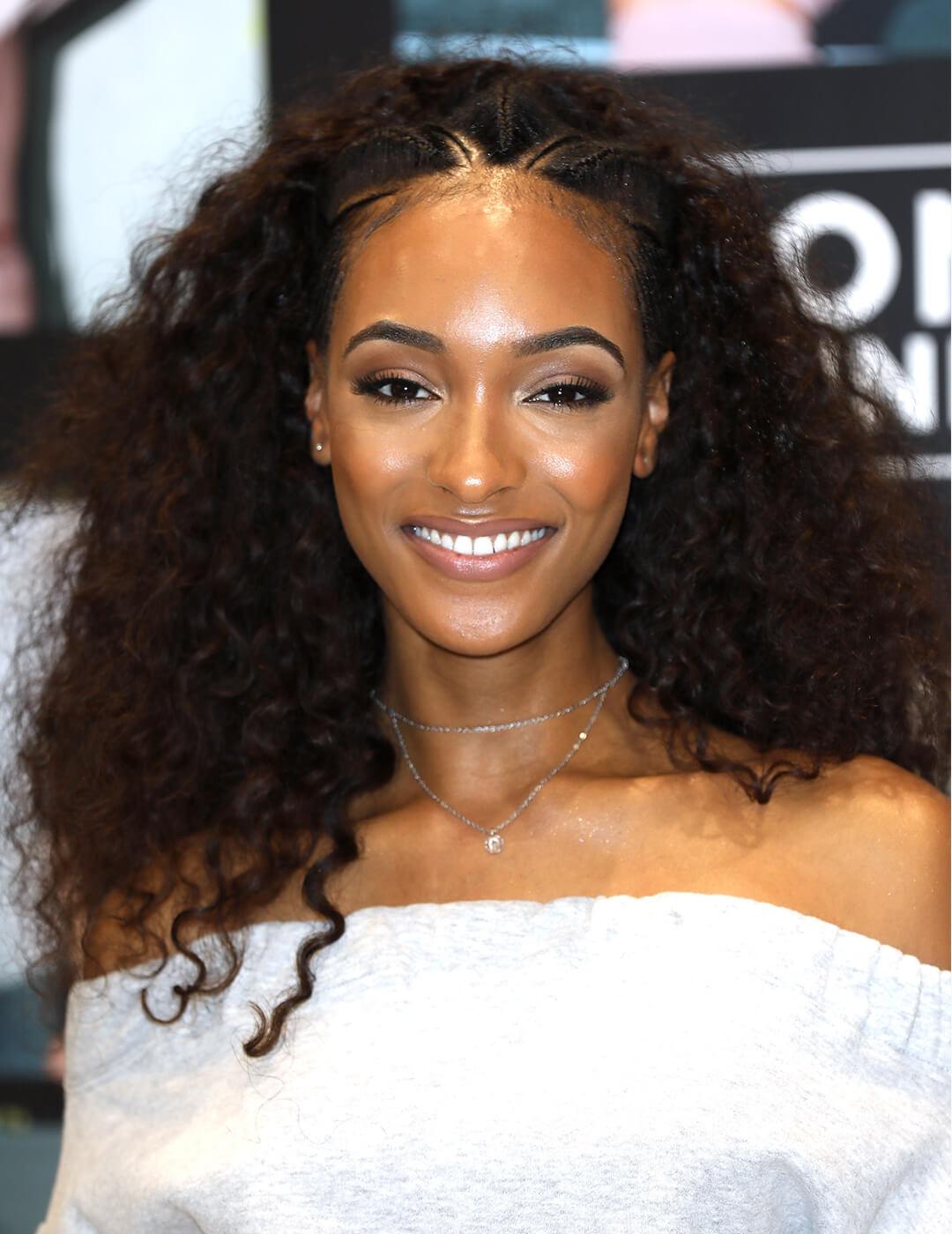 Jourdan Dunn looking glamorous in a white dress paired with an Albasso Braids hairstyle