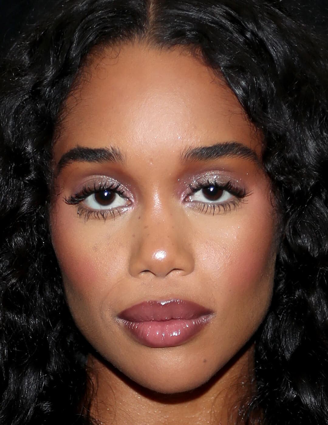 Close-up of Laura Harrier looking glam with a berry makeup look