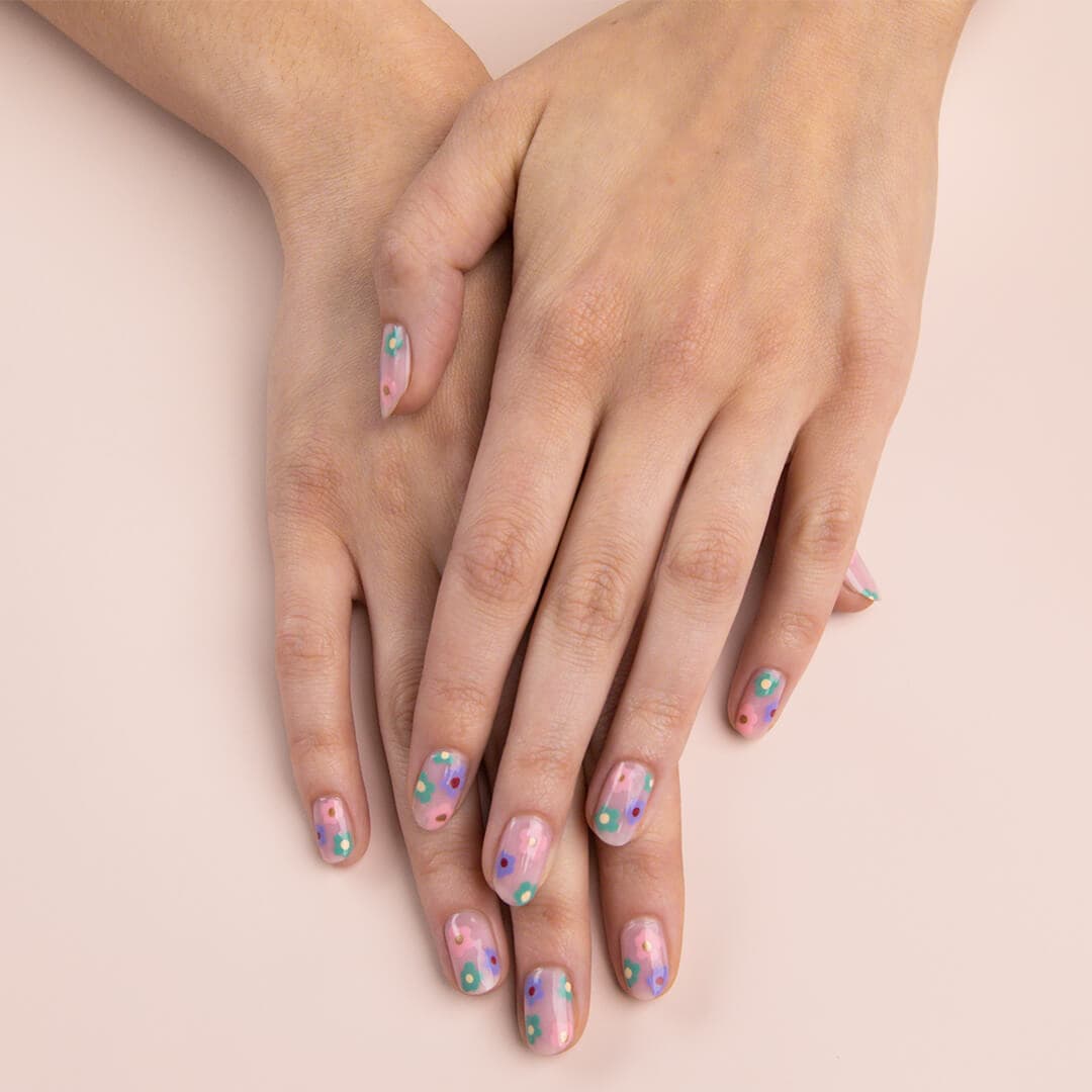 Image of model's hands with bright floral nail art