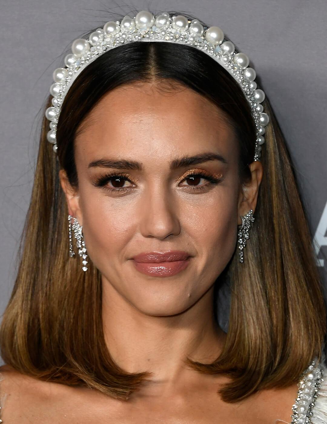 A photo of Jessica Alba showing her shoulder-length dark hair with white crystal headpiece 