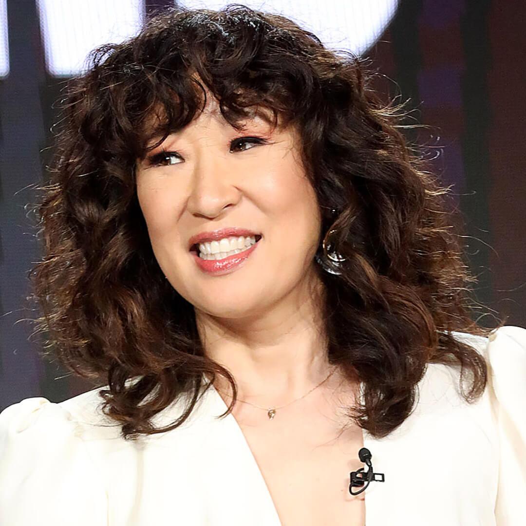 A photo of Sandra Oh with curly curtain bangs 