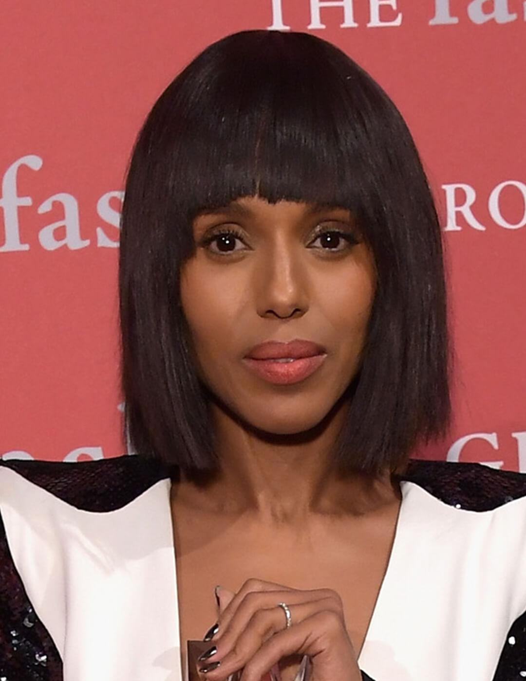 Kerry Washington looking fierce with blunt bangs and black and white outfit at the red carpet