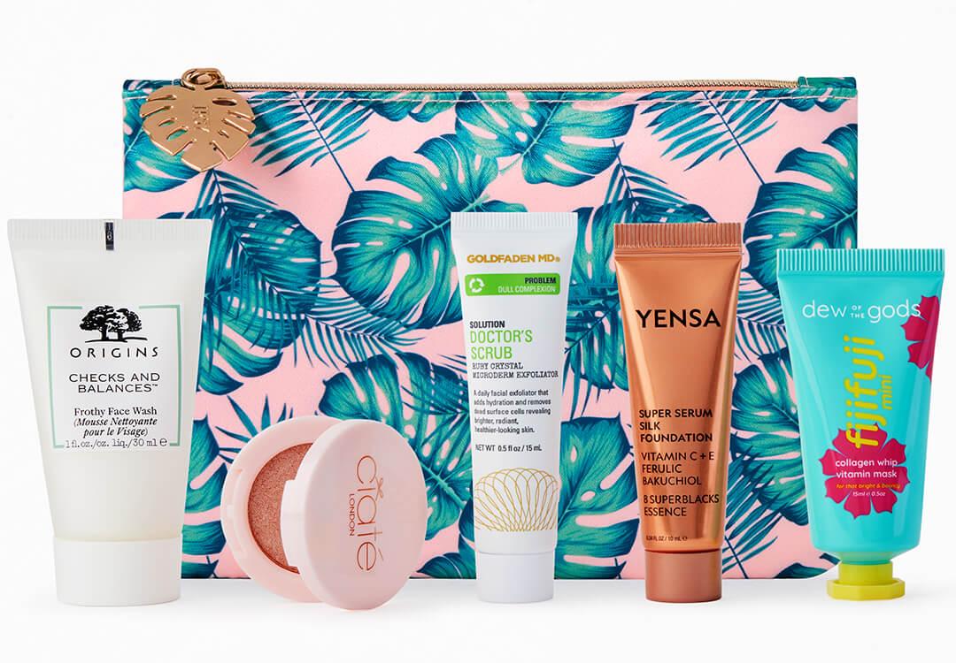 Beauty products from various brands arranged in front of IPSY palm print Glam Bag