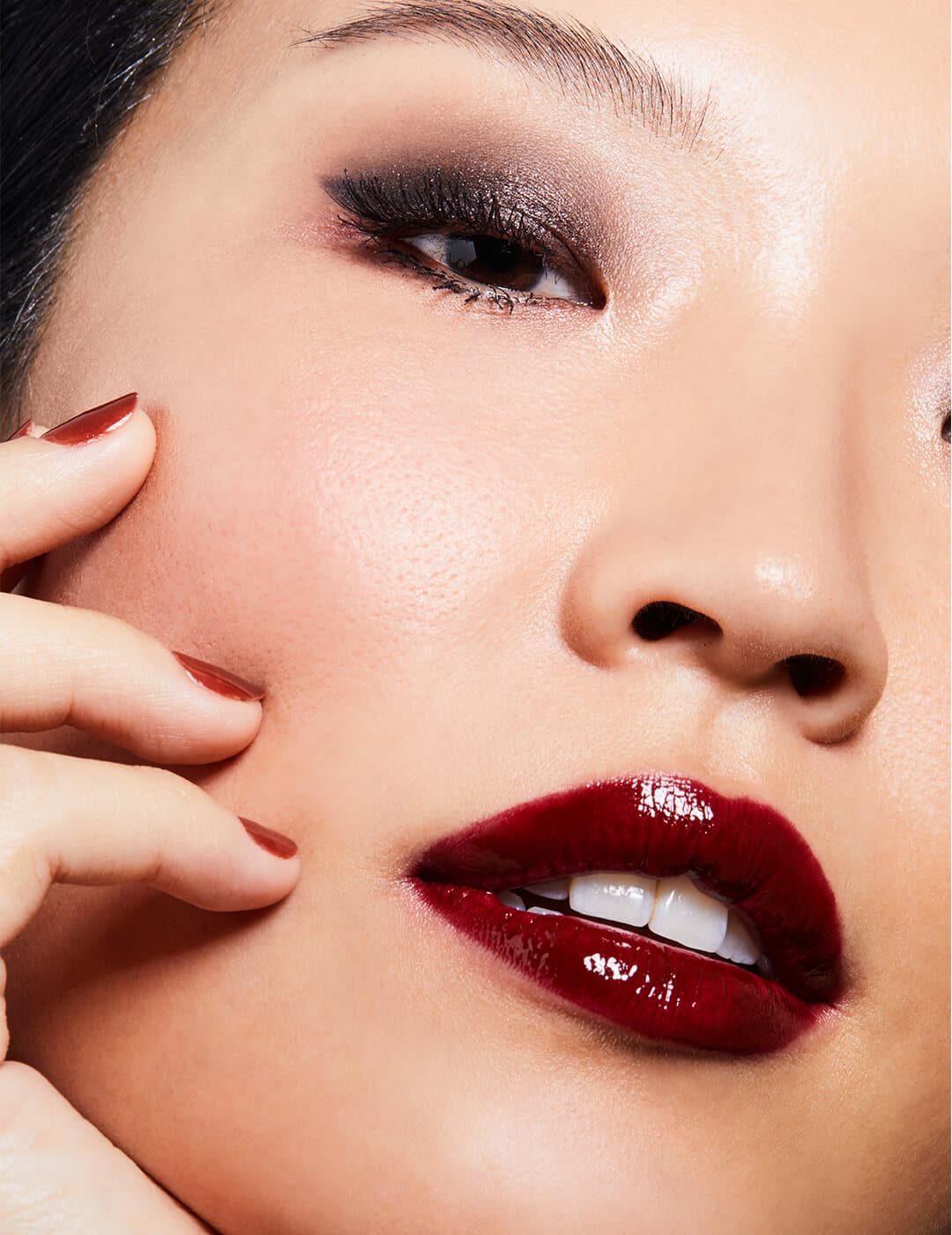 Close-up of a woman rocking dark eyeshadow and wine red lips