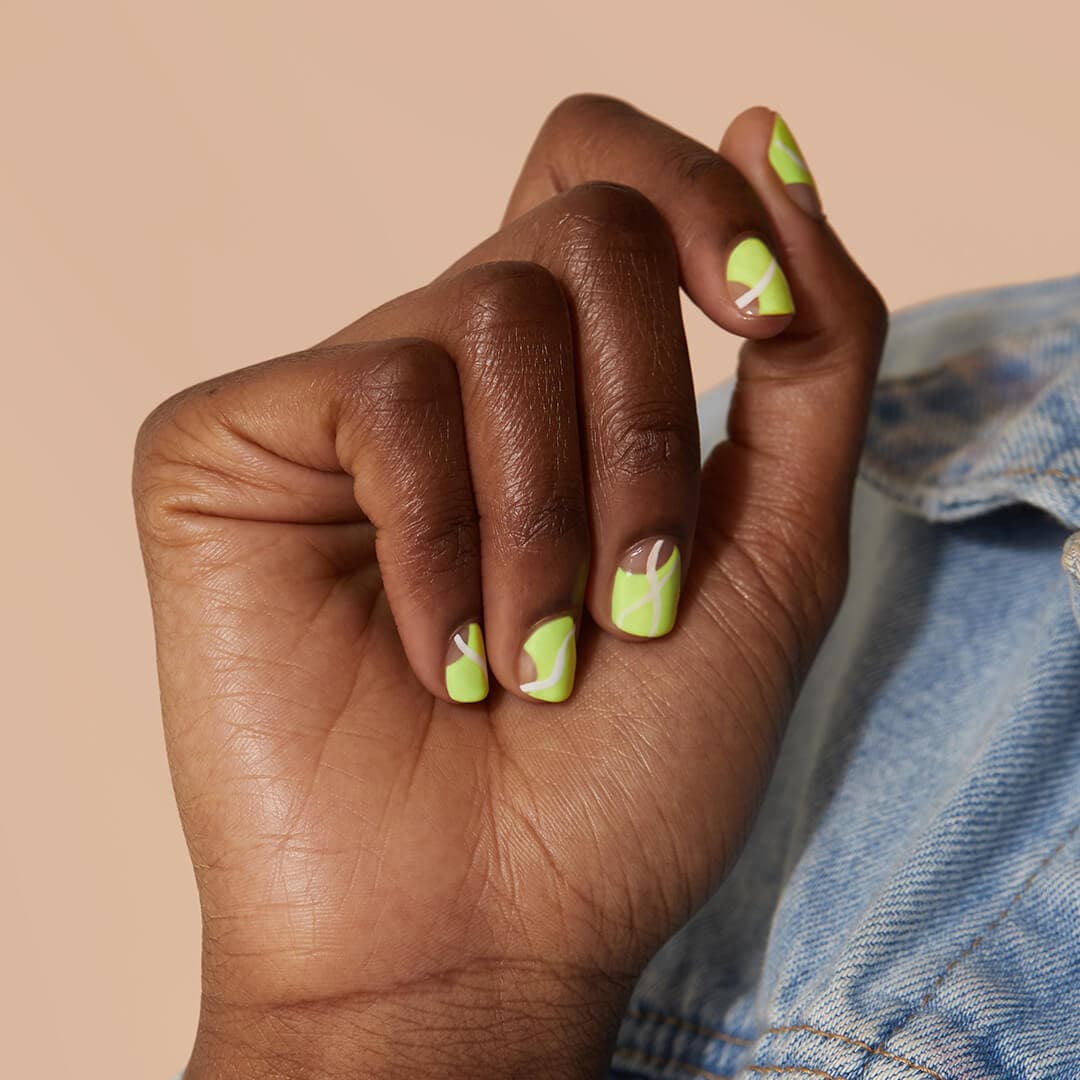 Image of a model's hand with abstract neon green and white nail art