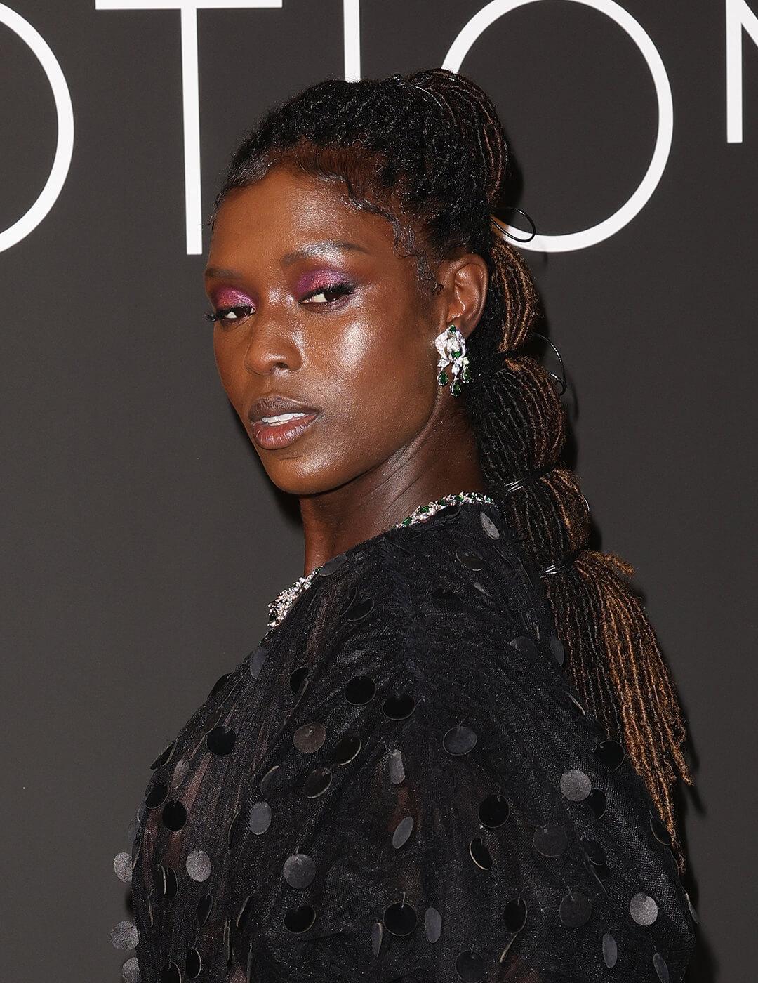 Jodie Turner-Smith looking in braided hairstyle