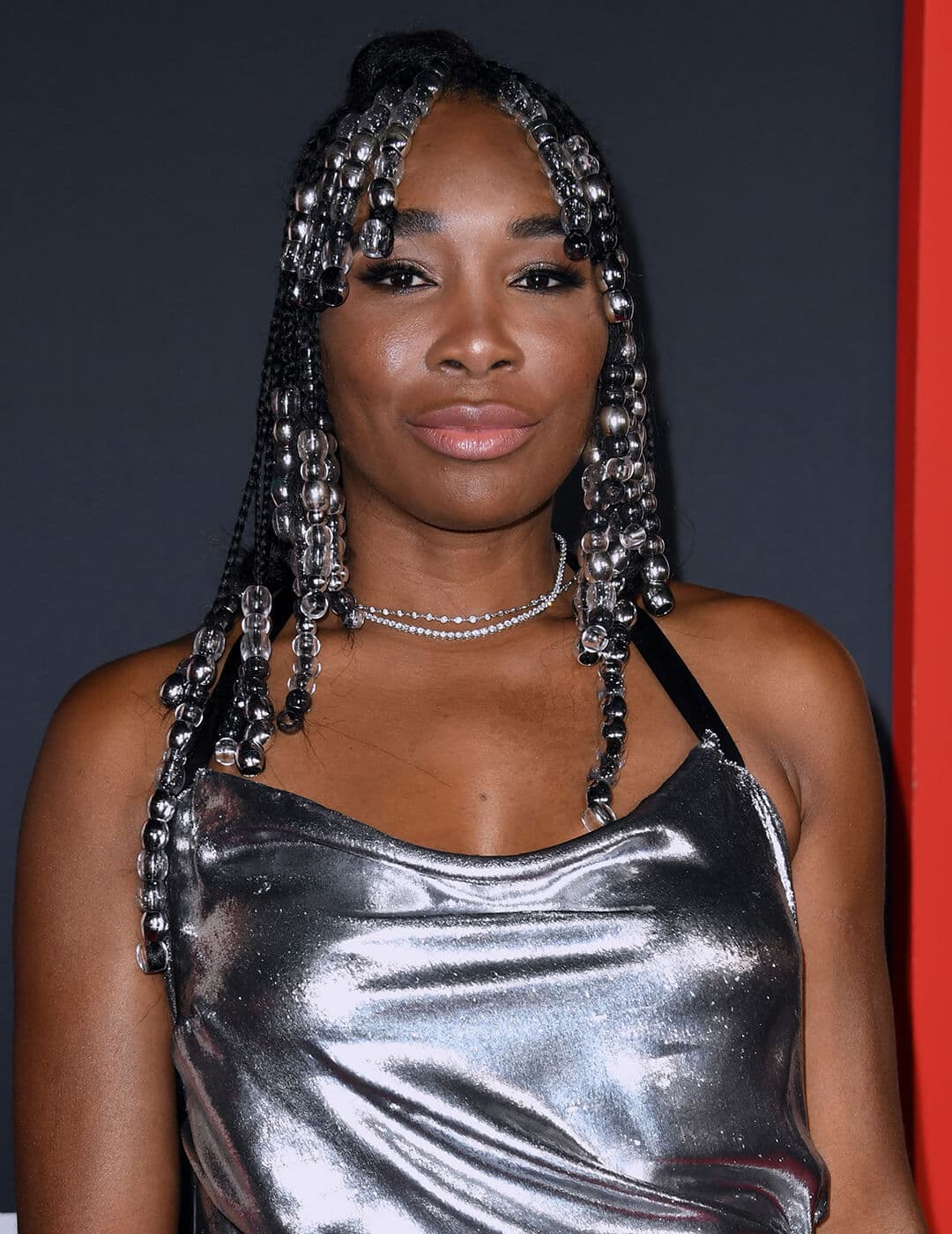 Venus Williams rocking a beaded and braided hairstyle and silver dress
