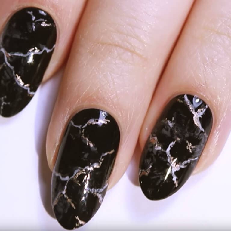 A close-up of the black marble nail art you can create by following these steps. 
