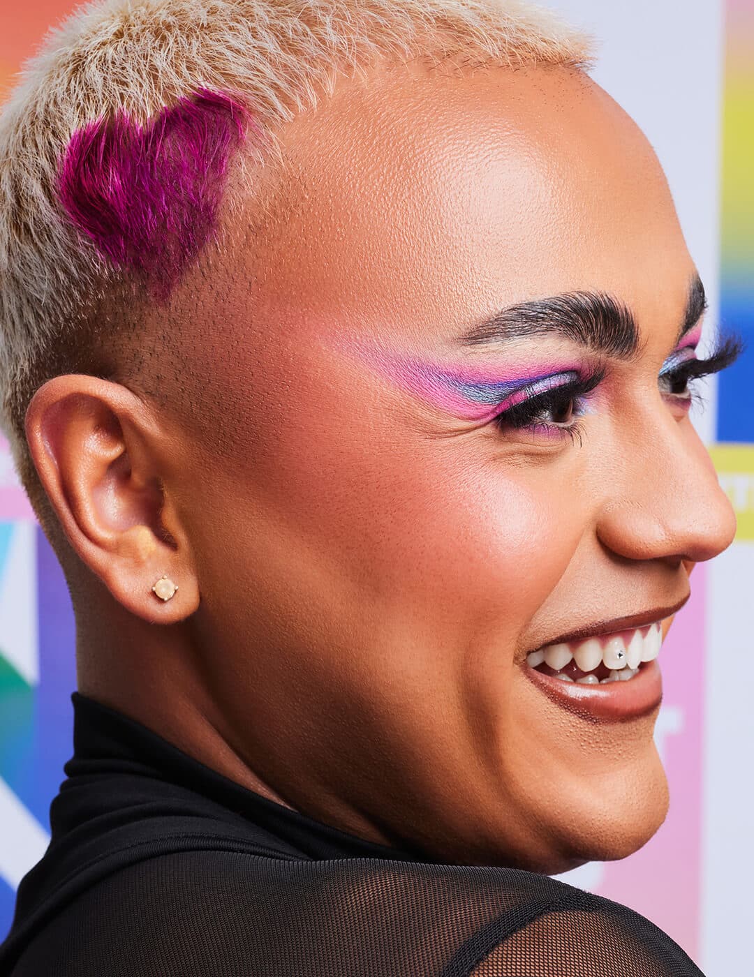 Close-up of Cristian Leal rocking a diffused shimmery purple and blue eyeshadow wing makeup look