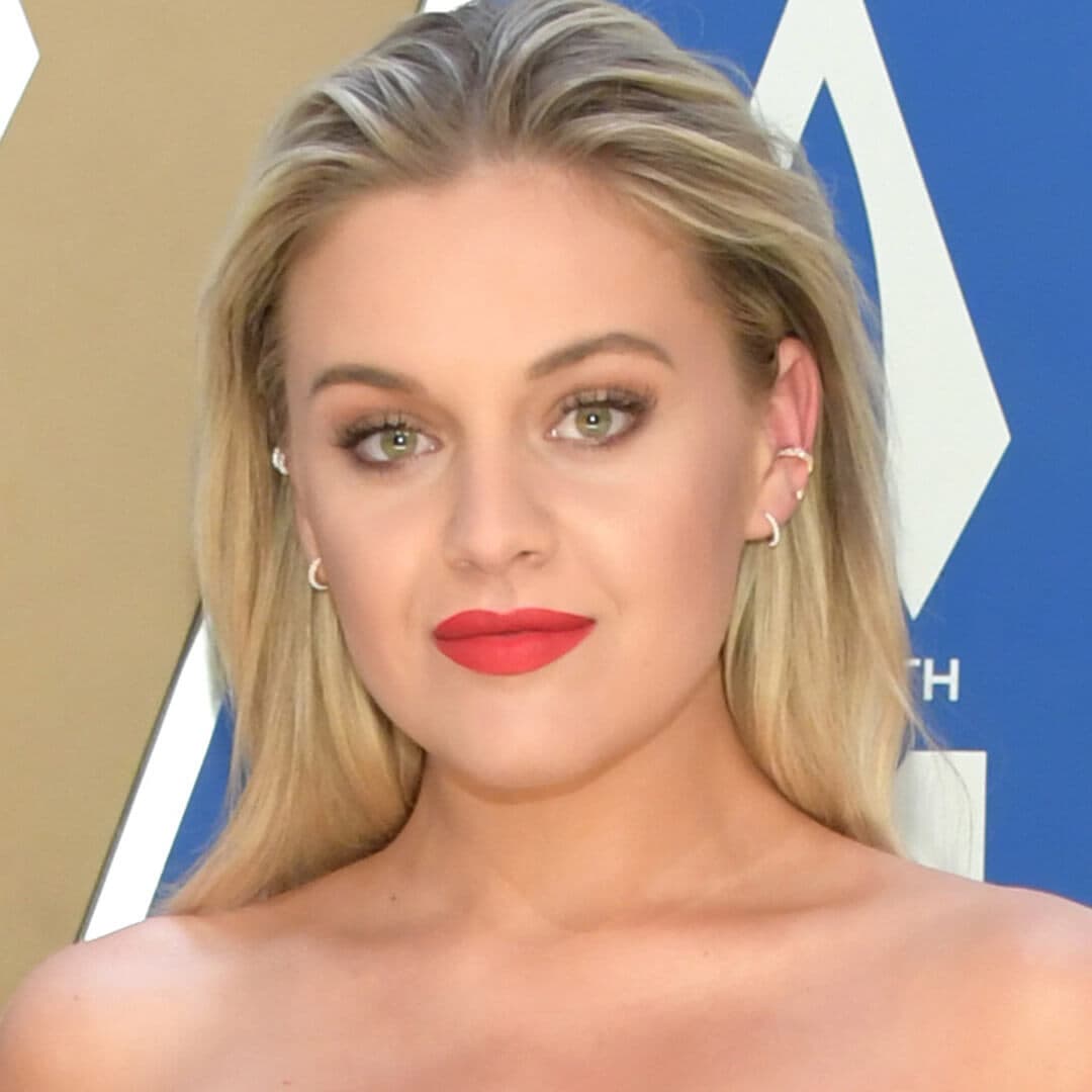 Kelsea Ballerini posing and rocking a pushed back hairstyle