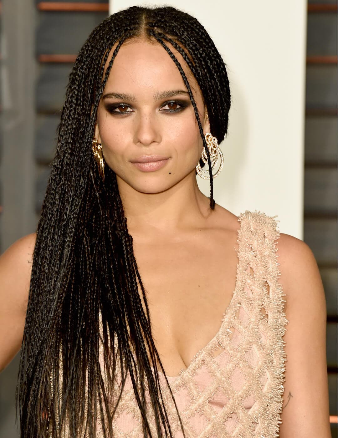 Zoe Kravitz rocking a micro braided hairstyle in a nude pink feathery dress