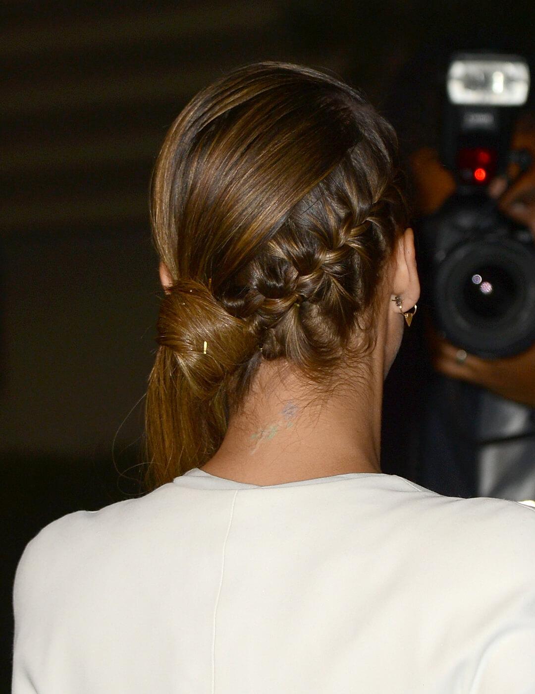 A photo of Jessica Alba showing off her back braided side ponytail looking in a camera
